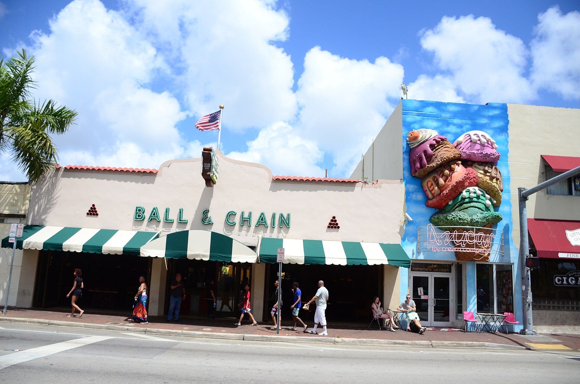 The green-striped awning of Ball & Chain on Calle Ocho, with a giant ice cream cone on the building next door