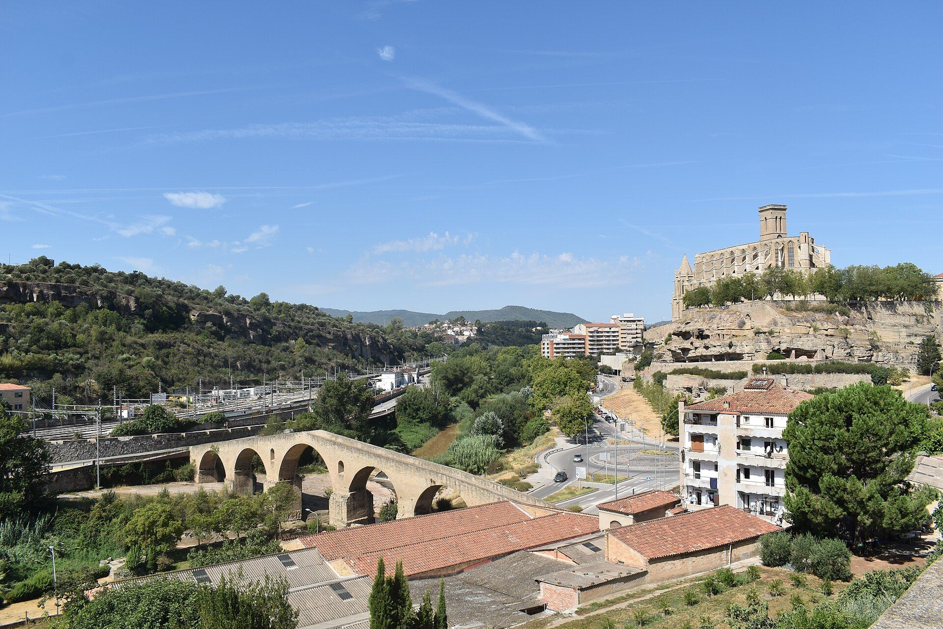 The Seu basilica on its sandstone bluff above the Cardener valley in Manresa, with the stone arches of the Pont Vell below