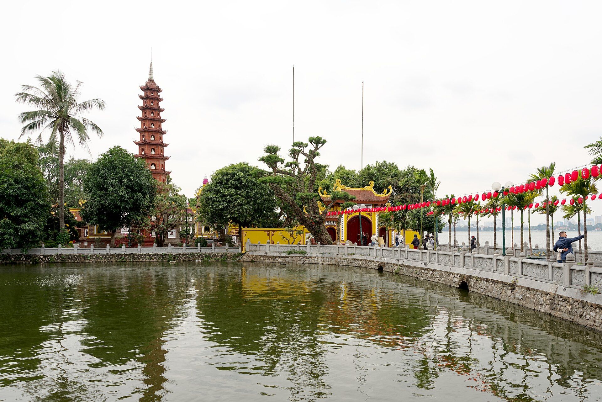 The red tower of Trấn Quốc Pagoda beside a pond on the edge of West Lake