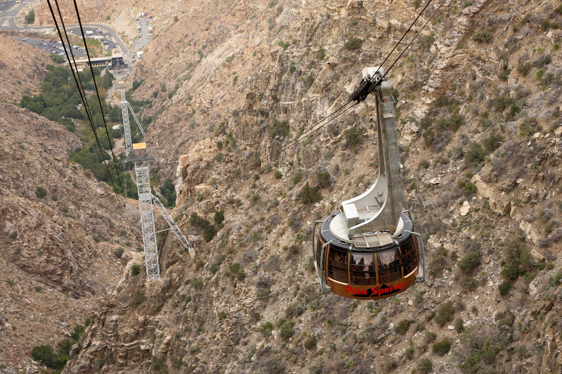 A Palm Springs aerial tram car on its cables high above the rock walls of Chino Canyon