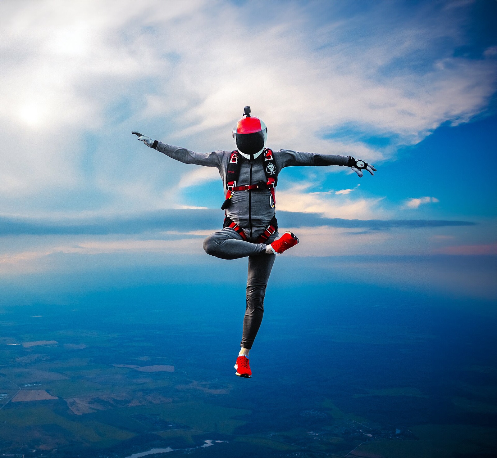 A skydiver in freefall against a blue sky, arms spread